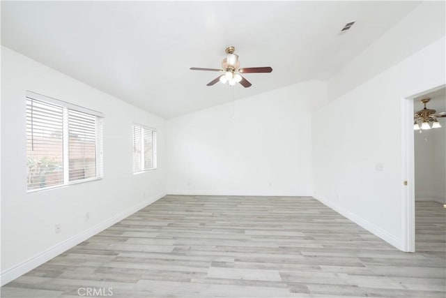 spare room with a ceiling fan, visible vents, and light wood-style flooring