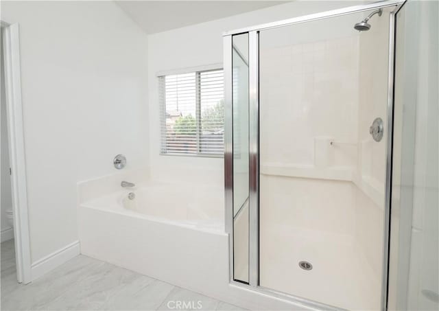 bathroom featuring baseboards, a shower stall, toilet, and a bath