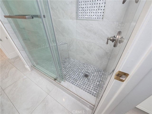 full bathroom featuring tile patterned flooring and a shower stall