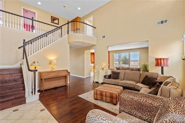 8309 Clover Creek Rd, Riverside, CA 92508 - living area featuring a towering ceiling, stairway, baseboards, recessed lighting, and wood finished floors