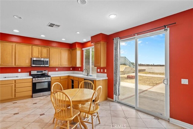 8309 Clover Creek Rd, Riverside, CA 92508 - kitchen featuring appliances with stainless steel finishes, a sink, baseboards, tile countertops, and recessed lighting