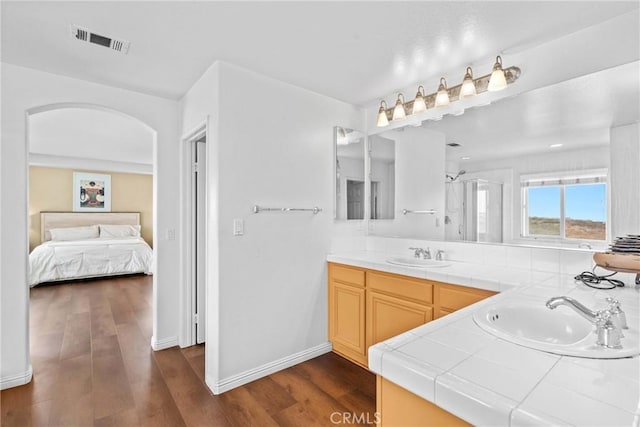 8309 Clover Creek Rd, Riverside, CA 92508 - ensuite bathroom with double vanity, wood finished floors, baseboards, and a shower