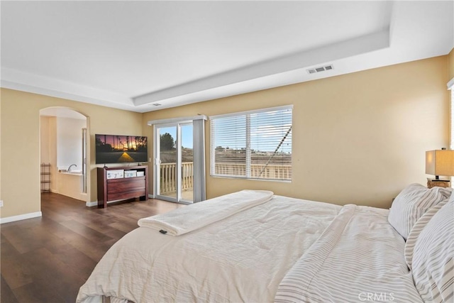8309 Clover Creek Rd, Riverside, CA 92508 - bedroom featuring a tray ceiling, access to exterior, dark wood finished floors, arched walkways, and baseboards