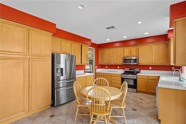8309 Clover Creek Rd, Riverside, CA 92508 - kitchen featuring appliances with stainless steel finishes, a sink, tile counters, recessed lighting, and light tile patterned flooring