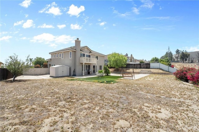 8309 Clover Creek Rd, Riverside, CA 92508 - back of property with a patio area, a fenced backyard, a balcony, a chimney, and stucco siding