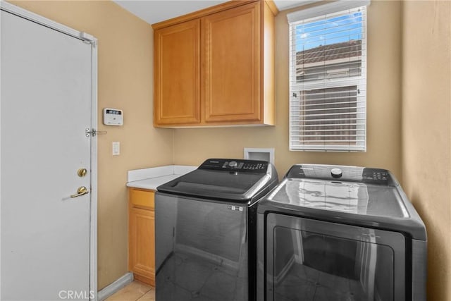 8309 Clover Creek Rd, Riverside, CA 92508 - laundry room featuring separate washer and dryer, cabinet space, and light tile patterned floors