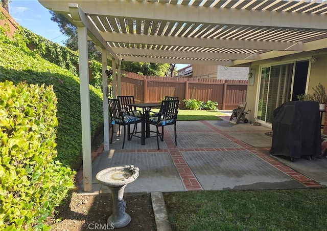 view of patio / terrace with a fenced backyard, a pergola, and outdoor dining area