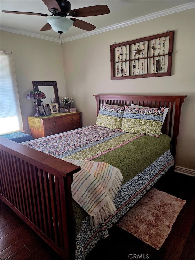 bedroom with crown molding, baseboards, a ceiling fan, and wood finished floors