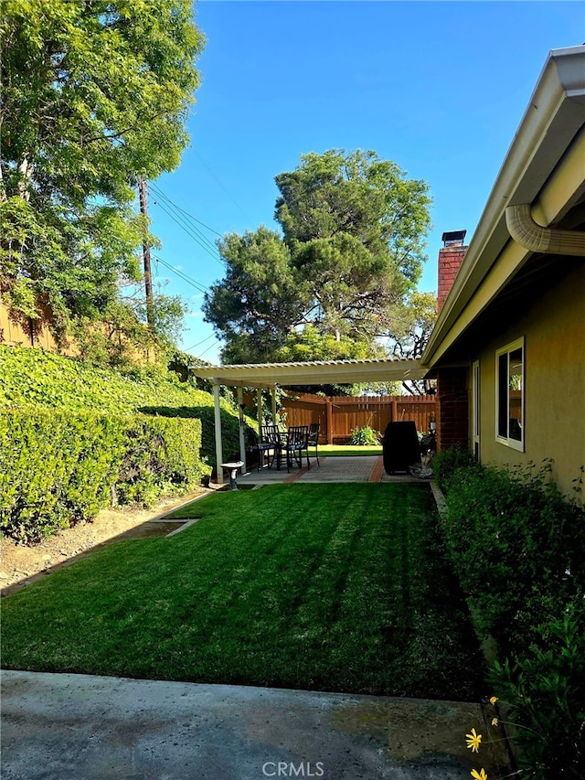view of yard with a patio and fence