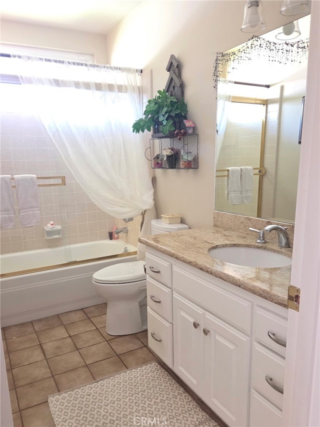 full bathroom with toilet, tile patterned floors, a healthy amount of sunlight, and vanity