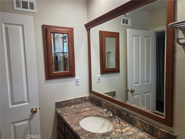 bathroom featuring visible vents and vanity