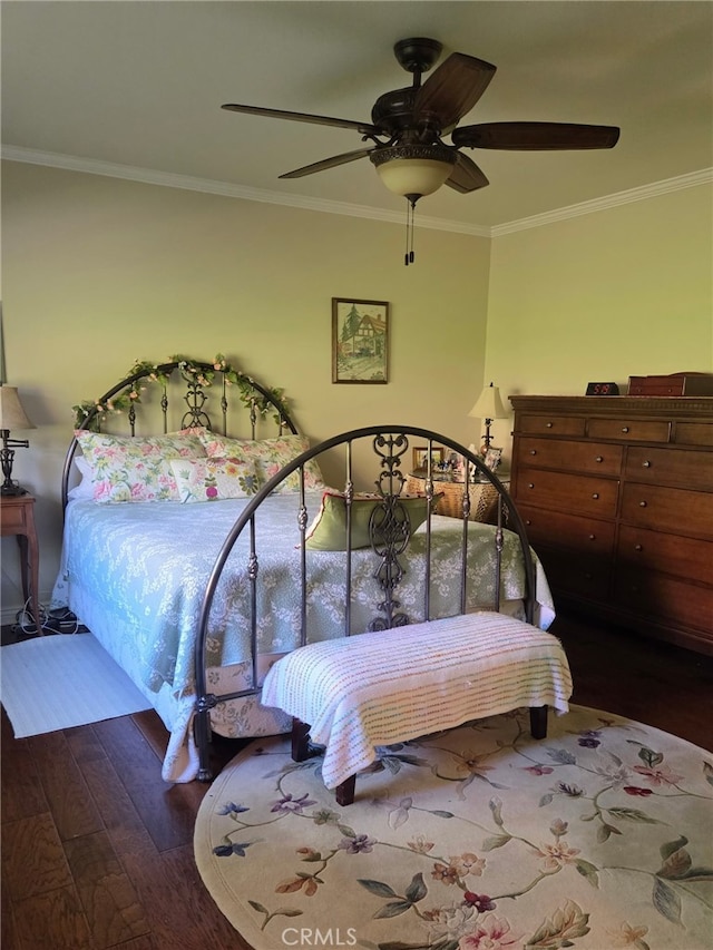 bedroom featuring ornamental molding, a ceiling fan, and wood finished floors