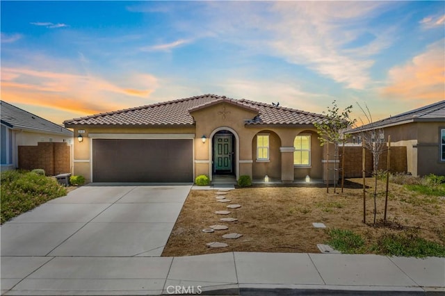 29101 Long Horn Ln, Winchester, CA 92596 - mediterranean / spanish home featuring a tiled roof, an attached garage, concrete driveway, and stucco siding