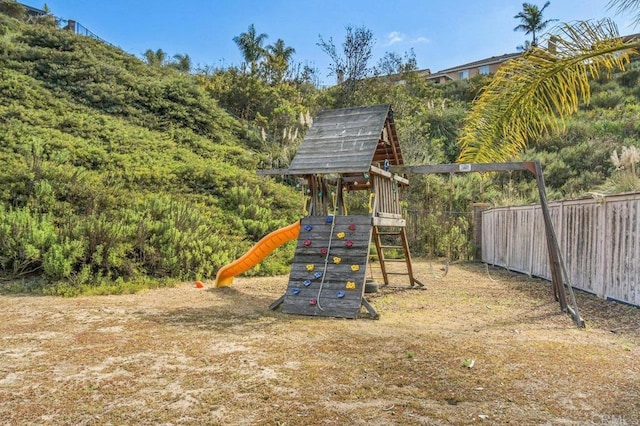 view of jungle gym featuring fence