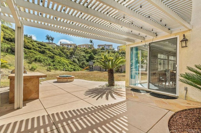view of patio with an outdoor fire pit and a pergola
