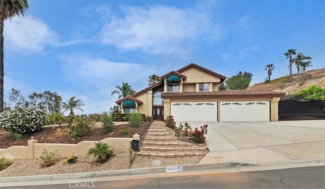 view of front of property with fence, stucco siding, an attached garage, driveway, and a tile roof