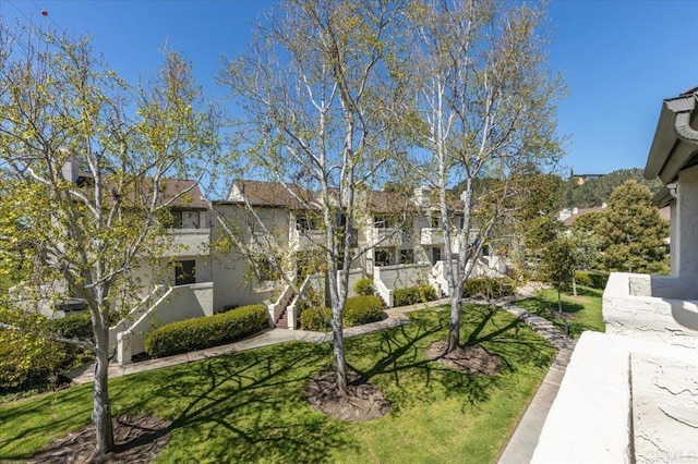 surrounding community featuring a lawn and stairs