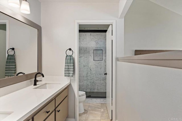 bathroom featuring double vanity, marble finish floor, toilet, a sink, and a stall shower