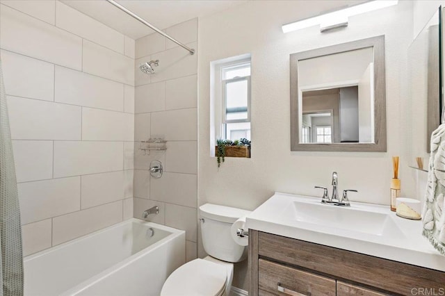 bathroom with vanity, shower / bathing tub combination, and toilet