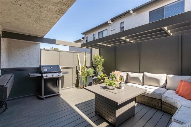 deck with an outdoor living space and a grill