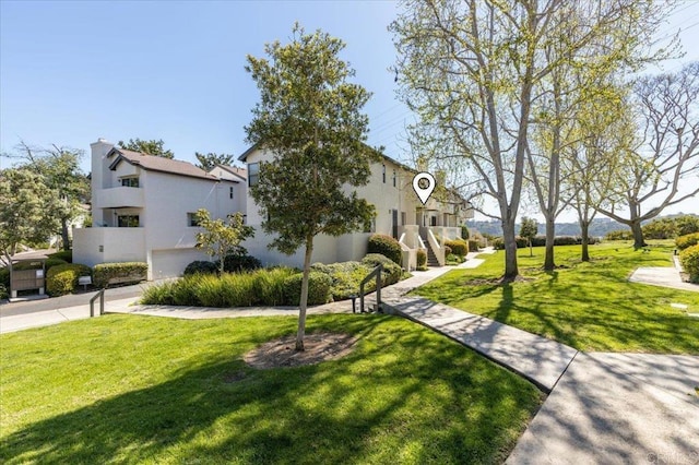 view of home's community featuring a lawn and a residential view