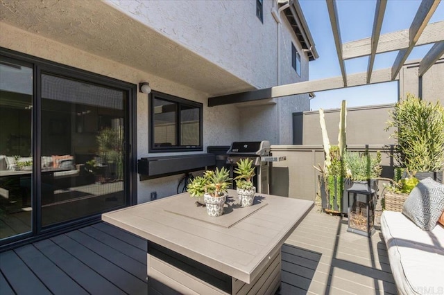wooden terrace with grilling area and outdoor dining area