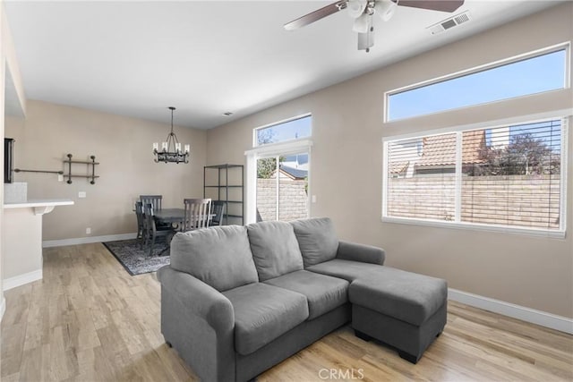 1128 Grass Valley Way, Santa Maria, CA 93454 - living room featuring light wood-style flooring, visible vents, a wealth of natural light, and ceiling fan with notable chandelier