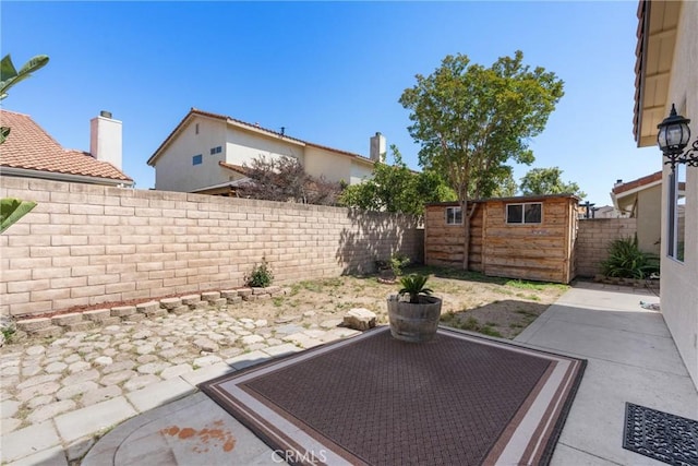 1128 Grass Valley Way, Santa Maria, CA 93454 - view of patio featuring an outdoor structure, a storage shed, and a fenced backyard