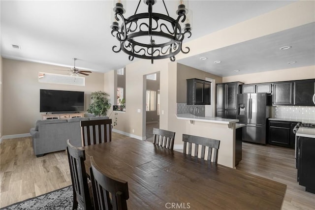 1128 Grass Valley Way, Santa Maria, CA 93454 - dining space featuring visible vents, light wood-type flooring, baseboards, ceiling fan with notable chandelier, and recessed lighting