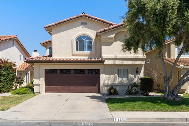 1128 Grass Valley Way, Santa Maria, CA 93454 - mediterranean / spanish home with a front lawn, a garage, stucco siding, concrete driveway, and a tiled roof