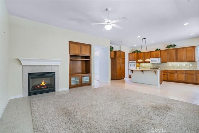 2612 Silverwood Way, Paso Robles, CA 93446 - unfurnished living room with light tile patterned flooring, a fireplace, ceiling fan, and recessed lighting