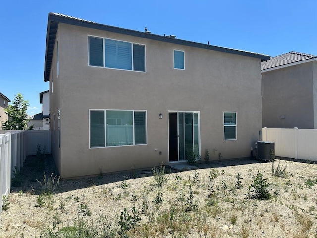 2511 Gunner Ridge Way, Rialto, CA 92377 - rear view of house featuring a fenced backyard, stucco siding, and central AC unit