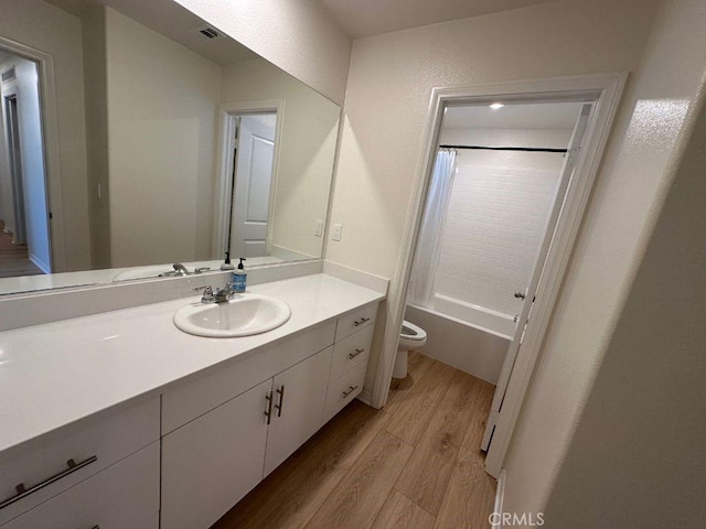 2511 Gunner Ridge Way, Rialto, CA 92377 - full bath featuring wood finished floors, vanity, toilet, and shower / bath combo with shower curtain