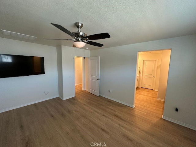 2511 Gunner Ridge Way, Rialto, CA 92377 - unfurnished bedroom with wood finished floors, baseboards, a textured ceiling, and a ceiling fan