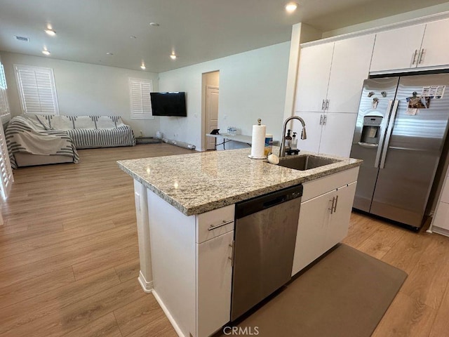 2511 Gunner Ridge Way, Rialto, CA 92377 - kitchen featuring stainless steel appliances, a sink, a kitchen island with sink, white cabinets, and light wood finished floors