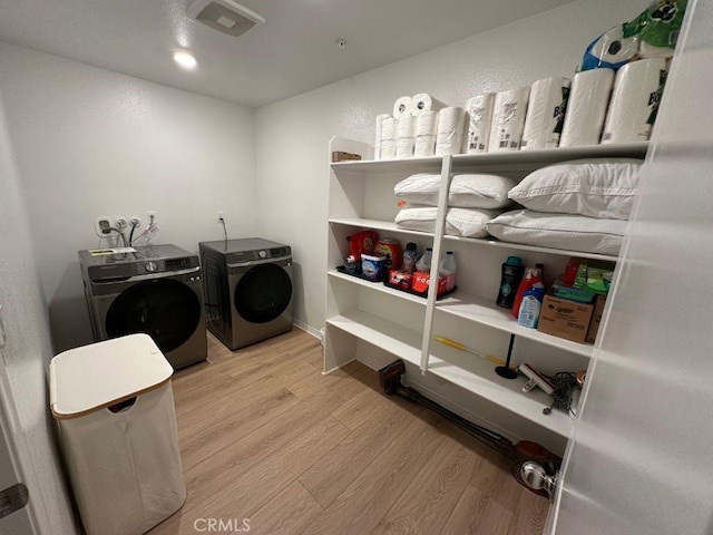 2511 Gunner Ridge Way, Rialto, CA 92377 - washroom with washing machine and dryer and wood finished floors