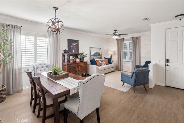 27975 Langley Pl, Castaic, CA 91384 - dining space with light wood-type flooring, crown molding, a chandelier, ceiling fan, and baseboards