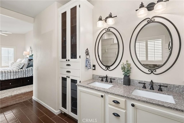 27975 Langley Pl, Castaic, CA 91384 - ensuite bathroom featuring double vanity and baseboards