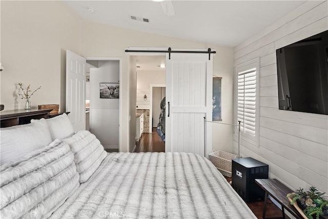 27975 Langley Pl, Castaic, CA 91384 - bedroom featuring a barn door, lofted ceiling, wooden walls, and ceiling fan