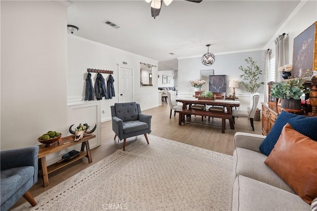 27975 Langley Pl, Castaic, CA 91384 - living area with crown molding, ceiling fan, light wood-style flooring, and a chandelier