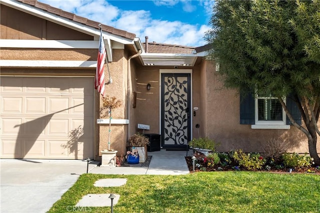 27975 Langley Pl, Castaic, CA 91384 - view of exterior entry with stucco siding, a garage, a lawn, and concrete driveway
