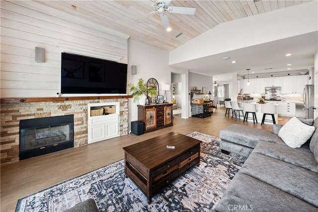 27975 Langley Pl, Castaic, CA 91384 - living area featuring a ceiling fan, light wood-style flooring, lofted ceiling, a fireplace, and recessed lighting