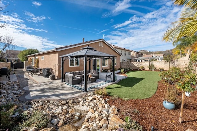 27975 Langley Pl, Castaic, CA 91384 - back of property featuring a gazebo, outdoor lounge area, a fenced backyard, stucco siding, and a patio area