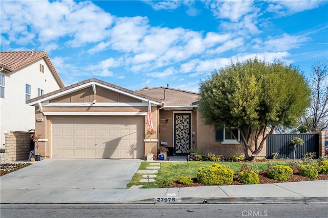 27975 Langley Pl, Castaic, CA 91384 - view of front of property featuring stucco siding, a garage, driveway, a tile roof, and fence