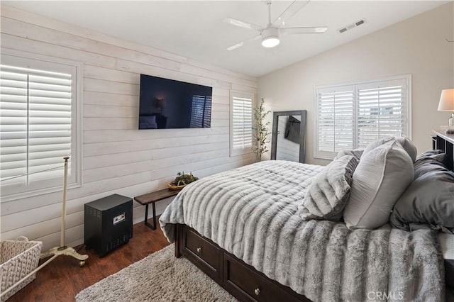 27975 Langley Pl, Castaic, CA 91384 - bedroom with vaulted ceiling, wood walls, dark wood-style flooring, and a ceiling fan