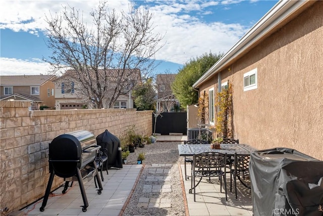 27975 Langley Pl, Castaic, CA 91384 - view of patio with fence, a grill, outdoor dining area, and central air condition unit