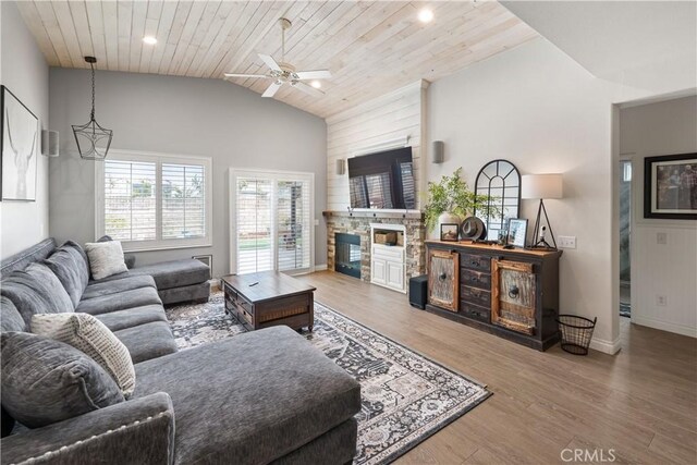 27975 Langley Pl, Castaic, CA 91384 - living room featuring vaulted ceiling, wooden ceiling, wood finished floors, a stone fireplace, and a ceiling fan