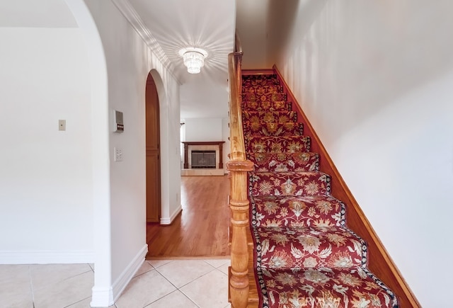 814 S Patton Ave Unit 2, San Pedro, CA 90731 - stairs with arched walkways, tile patterned flooring, and a fireplace