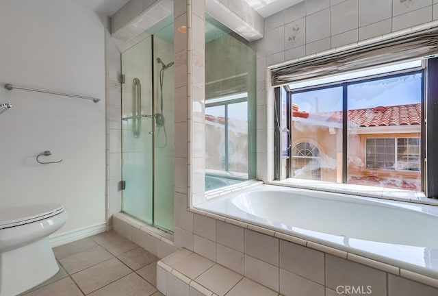814 S Patton Ave Unit 2, San Pedro, CA 90731 - full bathroom featuring toilet, tile patterned flooring, a stall shower, a bath, and baseboards