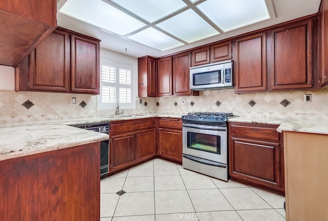 814 S Patton Ave Unit 2, San Pedro, CA 90731 - kitchen featuring stainless steel appliances, a sink, light tile patterned flooring, light stone countertops, and tasteful backsplash